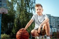 Portrait of a boy with a basketball on a basketball court. The concept of a sports lifestyle, training, sport, leisure, vacation Royalty Free Stock Photo