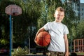 Portrait of a boy with a basketball on a basketball court. The concept of a sports lifestyle, training, sport, leisure, vacation Royalty Free Stock Photo