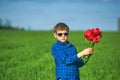 Portrait of a boy with a bouquet of red tulips Royalty Free Stock Photo