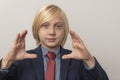 Portrait of a boy in a business suit making a frame with his hands Royalty Free Stock Photo