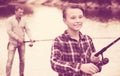 Portrait of boy casting line for fishing Royalty Free Stock Photo