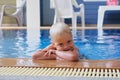 Portrait boy child in swimming pool home summer holiday, outdoors