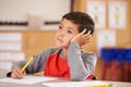 Portrait of a boy daydreaming in an elementary school class Royalty Free Stock Photo