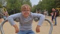 Portrait of boy with Down syndrome plays in playground. inclusive play equipment