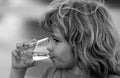 Portrait of boy drinking glass of water. Kid drinking water outdoor. Thirsty child. Royalty Free Stock Photo