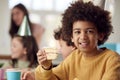 Portrait Of Boy Eating Birthday Cake At Party With Parents And Friends At Home Royalty Free Stock Photo