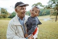 boy embracing grandfather in the backyard. grandson and grandparent outdoor Royalty Free Stock Photo