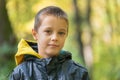 Portrait of boy in the forest smiling to the camera. Royalty Free Stock Photo