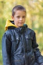 Portrait of boy in the forest smiling to the camera. Royalty Free Stock Photo