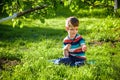 portrait of the boy in a garden, considers plants through a magnifying glass. Royalty Free Stock Photo