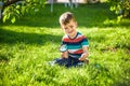 portrait of the boy in a garden, considers plants through a magnifying glass. Royalty Free Stock Photo