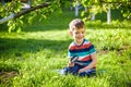 Portrait of the boy in a garden, considers plants through a magnifying glass Royalty Free Stock Photo