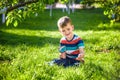 Portrait of the boy in a garden, considers plants through a magnifying glass Royalty Free Stock Photo