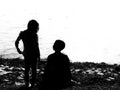 Portrait of boy and girl at the lakeside in black and white