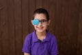 Portrait of boy in glasses with patch. Eye patch for glasses t treat lazy eye, amblyopia, strabismus. Royalty Free Stock Photo