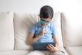 Portrait of boy in glasses with patch for glasses. Boy with tablet. Treat lazy eye, amblyopia, strabismus.  Remote learning. Dista Royalty Free Stock Photo