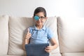 Portrait of boy in glasses with patch for glasses. Boy with tablet. Treat lazy eye, amblyopia, strabismus.  Remote learning. Dista Royalty Free Stock Photo