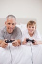 Portrait of a boy and his father playing video games Royalty Free Stock Photo