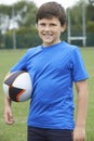 Portrait Of Boy Holding Ball On School Rugby Pitch