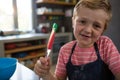 Portrait of boy holding spatula with batter Royalty Free Stock Photo