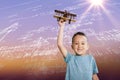 Composite image of portrait of boy holding toy airplane Royalty Free Stock Photo