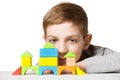 Portrait of a boy with house made of wooden blocks