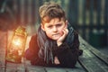 Portrait of a boy with a kerosene lamp Royalty Free Stock Photo