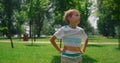 Portrait of boy looking around lawn close up. Cheerful child standing on meadow. Royalty Free Stock Photo