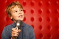 Portrait of boy with microphone on rack Royalty Free Stock Photo
