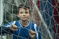 Portrait of a boy near the gate on the football field. Royalty Free Stock Photo