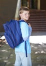 Portrait, boy and outdoor with backpack, education and school with knowledge, learning and student. Person, outside or