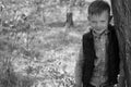 Portrait of Boy Outdoors Leaning Against Tree Royalty Free Stock Photo