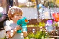 Portrait of a boy play with soap bubbles holding bubble gun Royalty Free Stock Photo