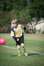Portrait of a boy playing soccer, ready to kick the ball Royalty Free Stock Photo