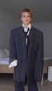 Portrait, boy and pretend suit on male person, oversized business clothes for dream job on child. Dress up, kid and Royalty Free Stock Photo