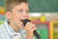 Portrait of a cute boy singing karaoke Royalty Free Stock Photo