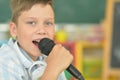 Portrait of boy singing karaoke at home Royalty Free Stock Photo