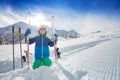 Portrait of a boy sit in snow with ski on slope Royalty Free Stock Photo