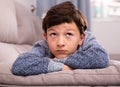 Portrait of boy sitting on comfortable sofa in the lounge room Royalty Free Stock Photo