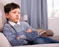 Portrait of boy sitting on comfortable sofa in the lounge room Royalty Free Stock Photo