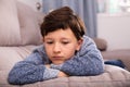 Portrait of boy sitting on comfortable sofa in the lounge room Royalty Free Stock Photo