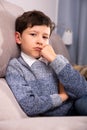 Portrait of boy sitting on comfortable sofa in the lounge room Royalty Free Stock Photo