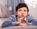 Portrait of boy sitting on comfortable sofa in the lounge room Royalty Free Stock Photo