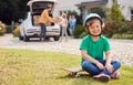 Portrait Of Boy With Skateboard Outside New Family Home On Moving Day Unloading Boxes From Car Royalty Free Stock Photo