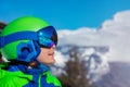 Portrait of a boy smile in ski helmet and mask over mountain Royalty Free Stock Photo