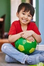 Portrait, boy and soccer ball in home, smile and outdoor in patio, adorable and cute kid in weekend. House, wellness and