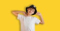 Portrait of boy stretching happily. Teenage Boy In Casual Style Outfit Isolated On Yellow Background. Back to school web Royalty Free Stock Photo