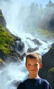 Portrait boy on summer waterfall background