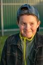 Portrait of a boy outdoors, at sunset