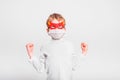Portrait of boy in superhero mask with his mouth covered with a medical mask to protect himself from viral infections and diseases